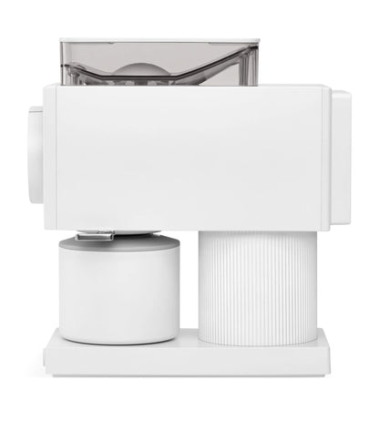 White cylindrical object with a transparent top on a white background